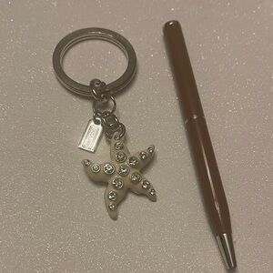 Coach Beige Starfish Keychain with Rhinestones and a Brown Coach Pen